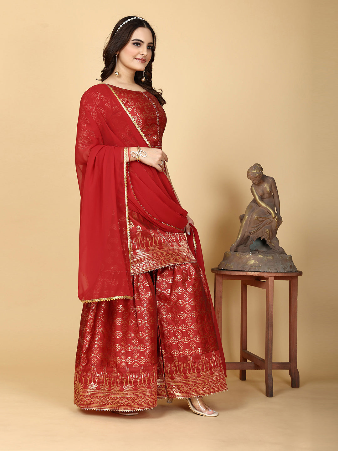 A traditional ensemble featuring a woven kurta adorned with ethnic motifs, complemented by flowing sharara pants and a matching dupatta
