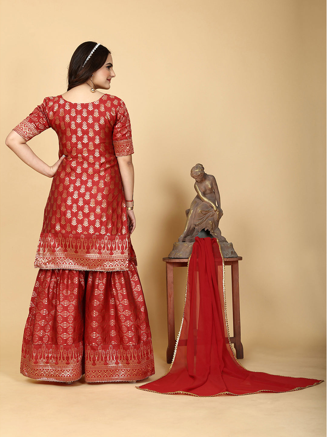 A traditional ensemble featuring a woven kurta adorned with ethnic motifs, complemented by flowing sharara pants and a matching dupatta