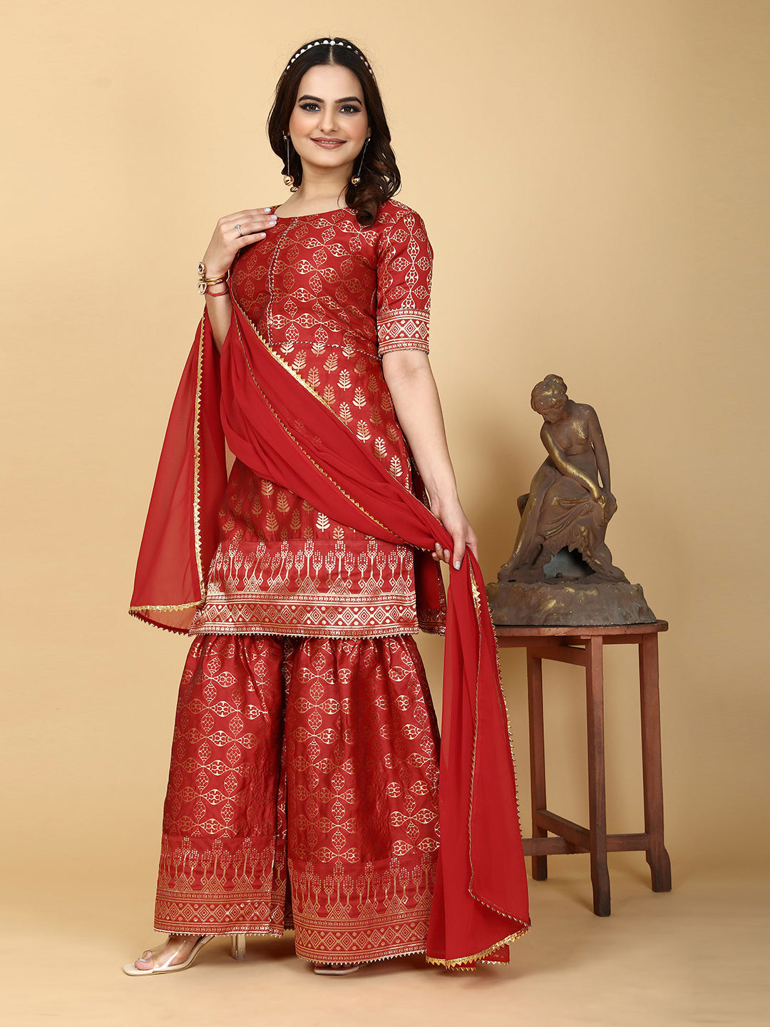 A traditional ensemble featuring a woven kurta adorned with ethnic motifs, complemented by flowing sharara pants and a matching dupatta