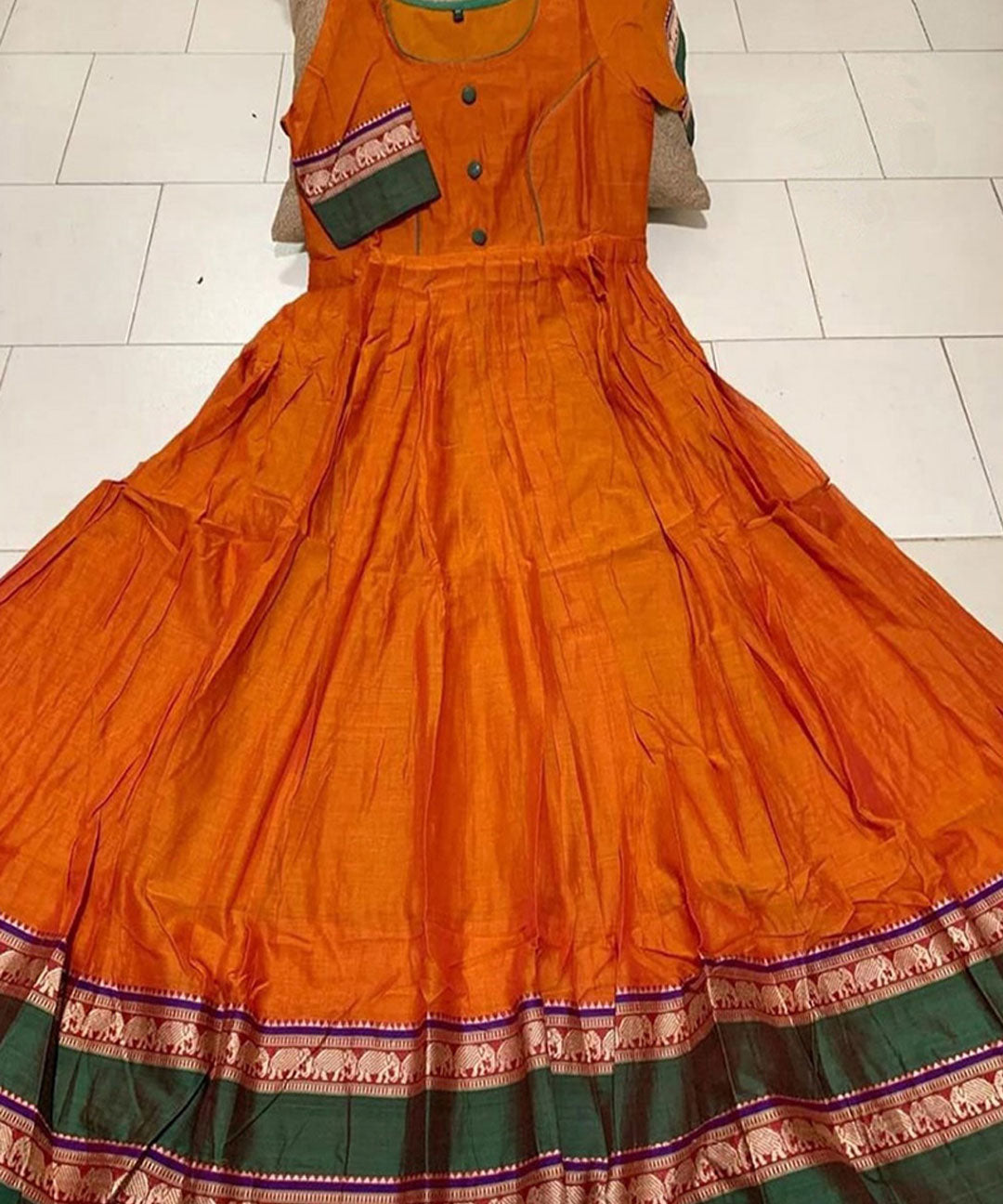 Flamboyant orange colored partywear satin silk gown with trendy print, ideal for fashionable occasions.
