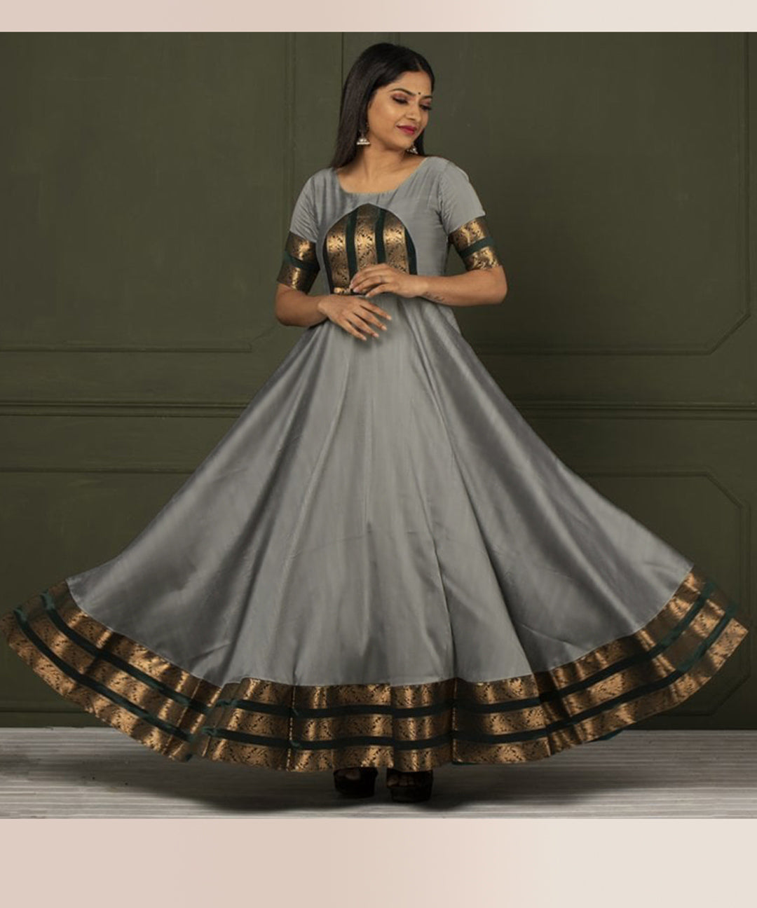 Glorious grey colored festive wear gown crafted from woven Tapetta silk, ideal for special occasions.