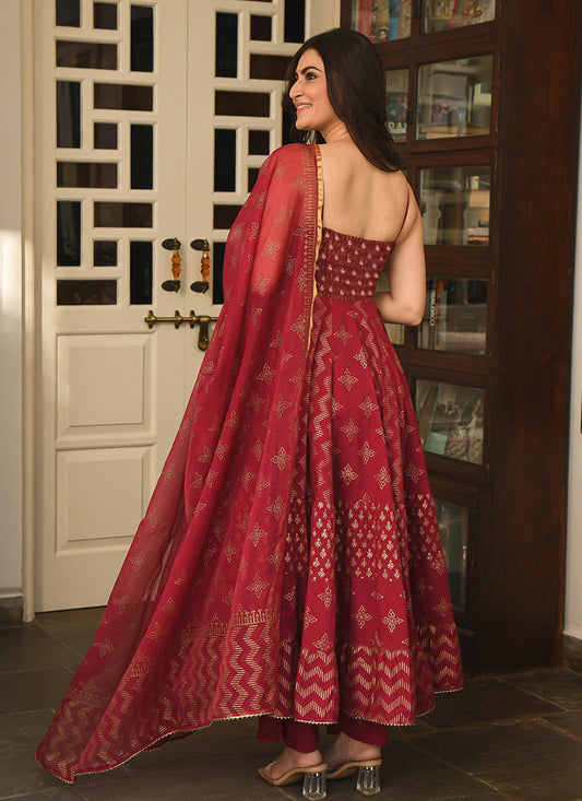 Magnetic maroon colored partywear stitched woven jacquard suit set, perfect for elegant and celebratory occasions.