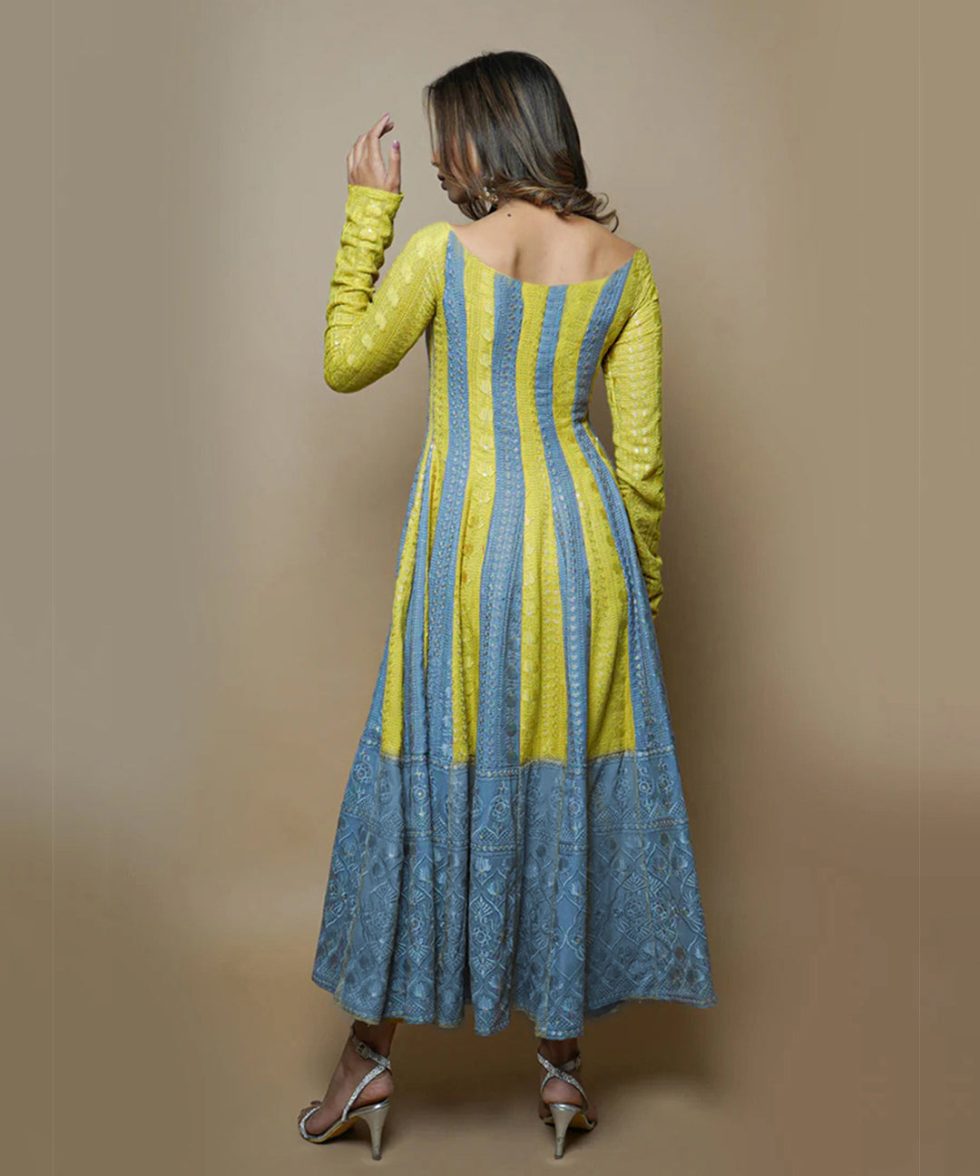 A model wearing a Medha Rayon Chikankari Suit Set, showcasing delicate white embroidery on a stylish, flowing fabric.