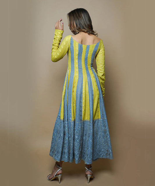 A model wearing a Medha Rayon Chikankari Suit Set, showcasing delicate white embroidery on a stylish, flowing fabric.