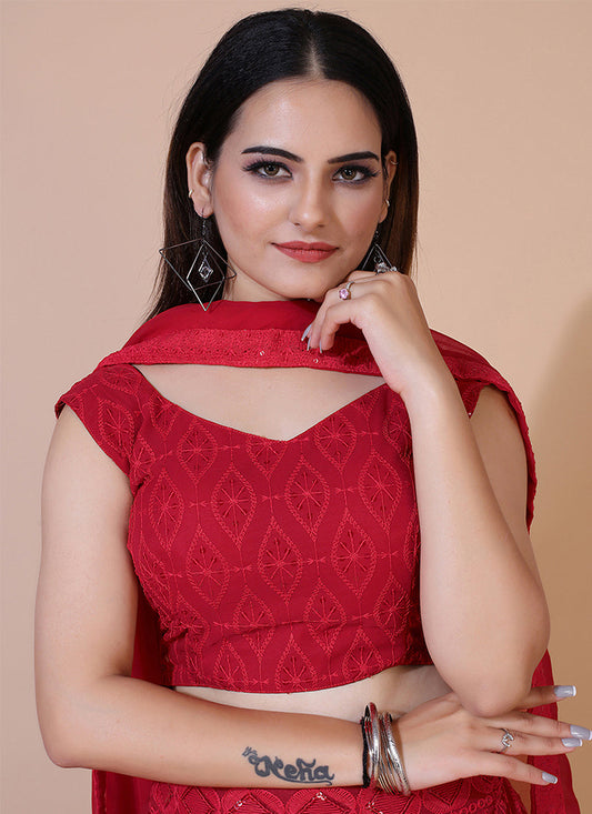 Red A-line Lucknowi Chikankari work stitched lehenga choli, ideal for traditional and festive celebrations with intricate embroidery.