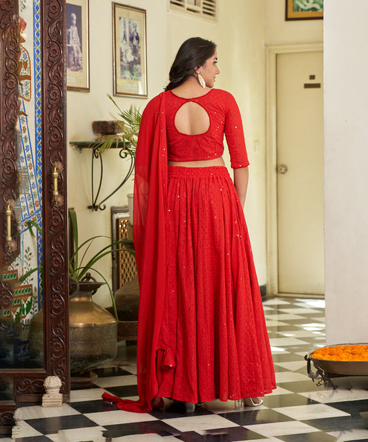 Red A-line lehenga choli with Lucknowi Chikankari work, showcasing intricate embroidery and an elegant design