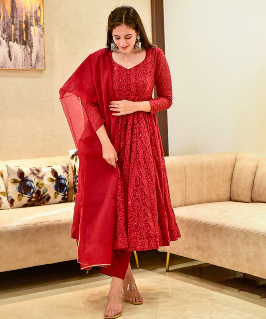 A red georgette Anarkali suit featuring intricate Lucknowi embroidery.