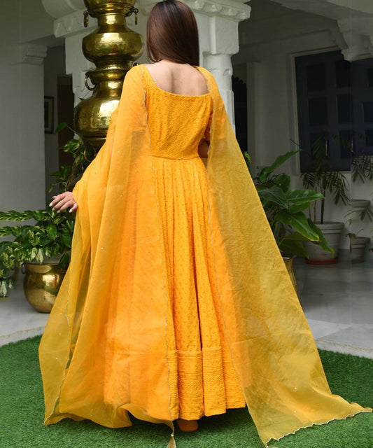 Yellow Designer Anarkali Gown in Cotton adorned with Lucknowi Chikankari Embroidery, showcasing intricate craftsmanship and elegance.
