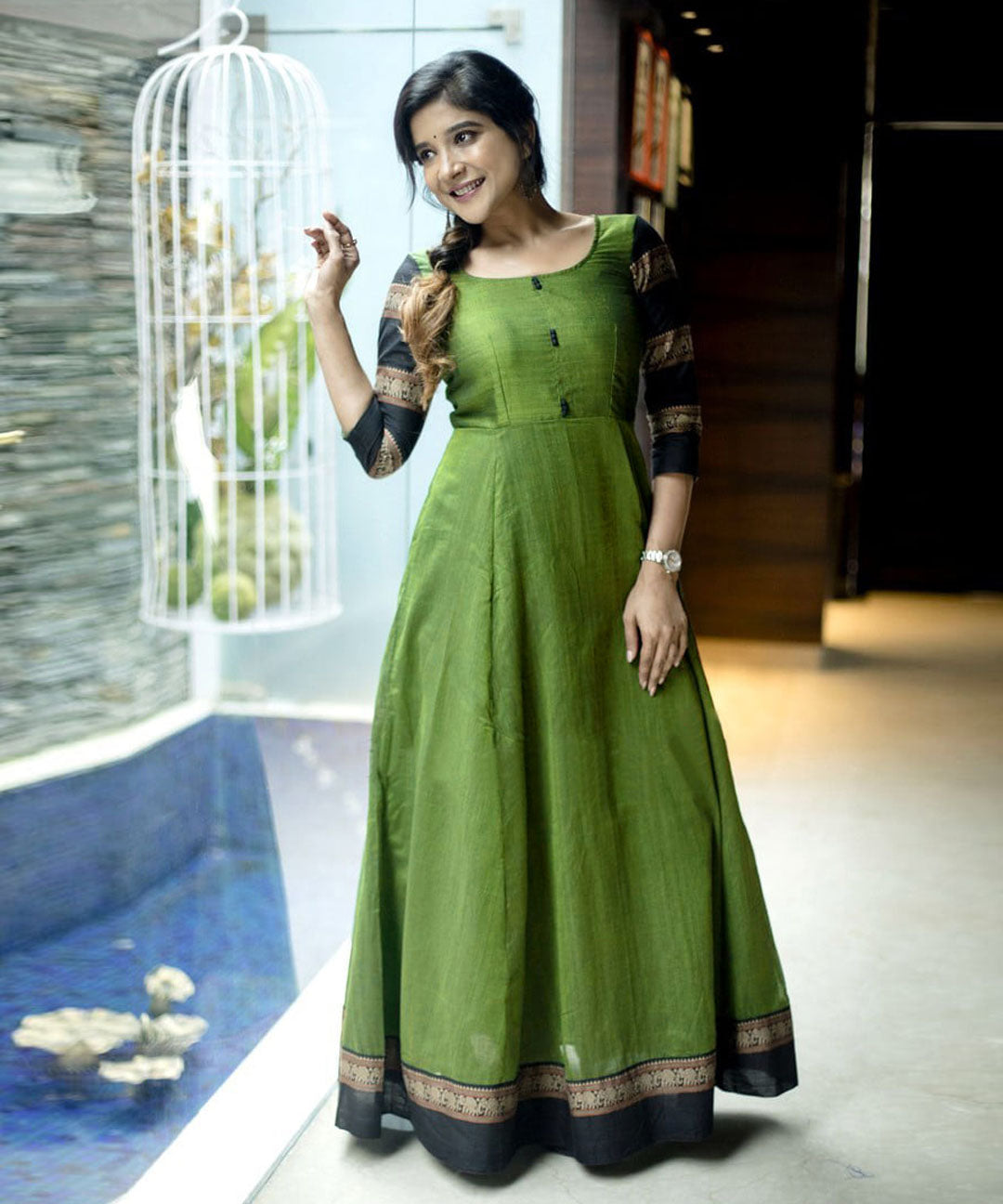 Designer green colored party wear readymade cotton gown, perfect for stylish occasions with a comfortable fit.