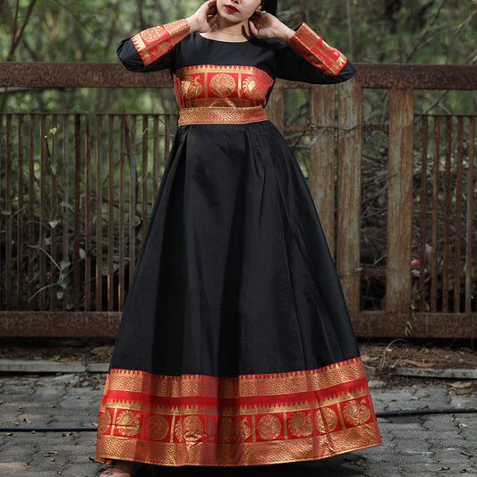 A flattering black gown, perfect for festive occasions, featuring a beautiful woven tapetta silk design.