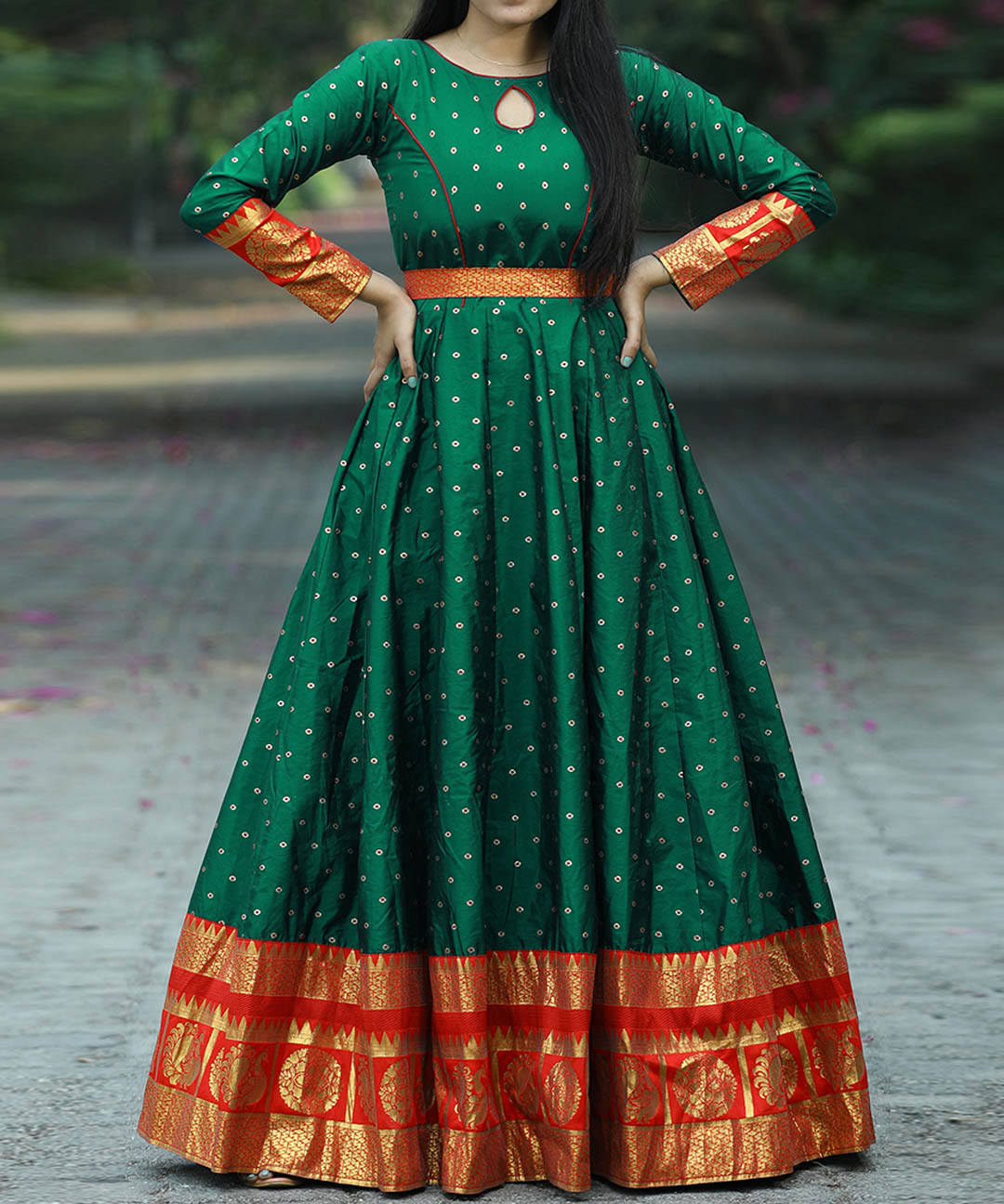 Flattering green colored festive wear gown made from woven Tapetta silk, perfect for celebrations.