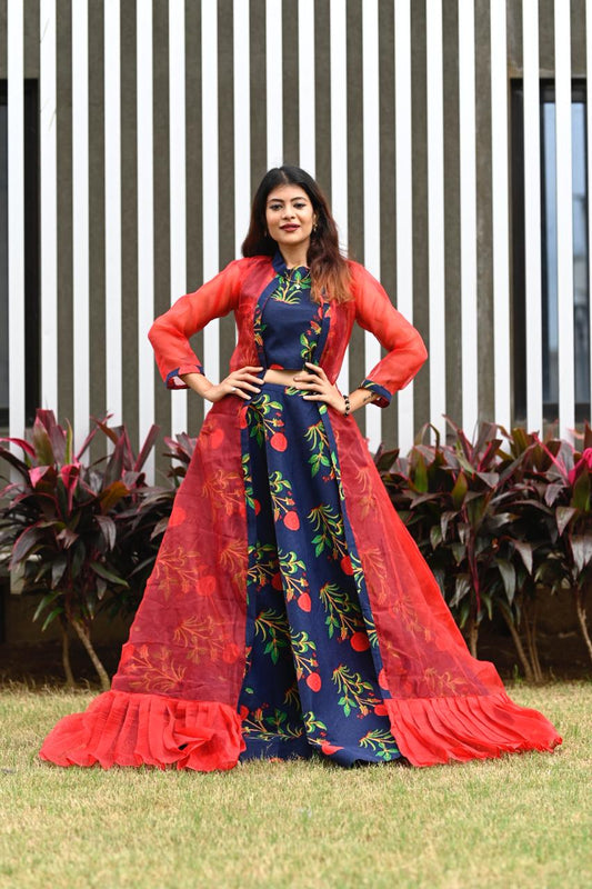 A vibrant party wear lehenga choli featuring a colorful floral cotton skirt and a flowy net dupatta.