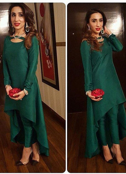 A stunning dark green party gown crafted from flowing satin silk. The dress has a unique twist with a stitched dhoti-style pant, creating a contemporary and glamorous look.