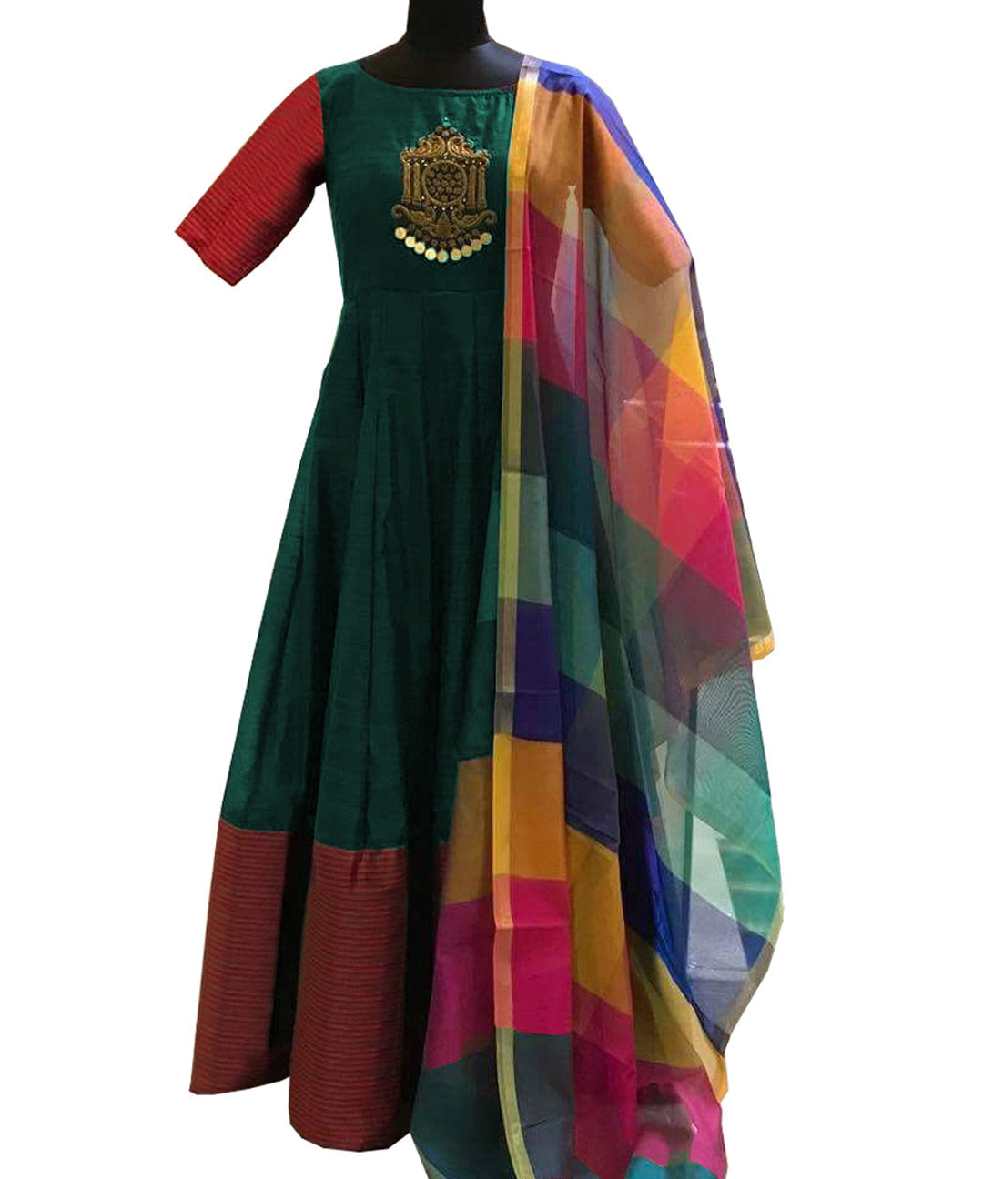 Green Tapeta silk gown adorned with diamond, embroidery, and mirror work, paired with a cotton silk dupatta for a stunning ensemble.