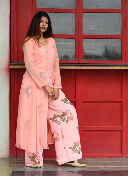 Lovely light peach colored partywear printed georgette top-bottom palazzo set, perfect for stylish and festive occasions.