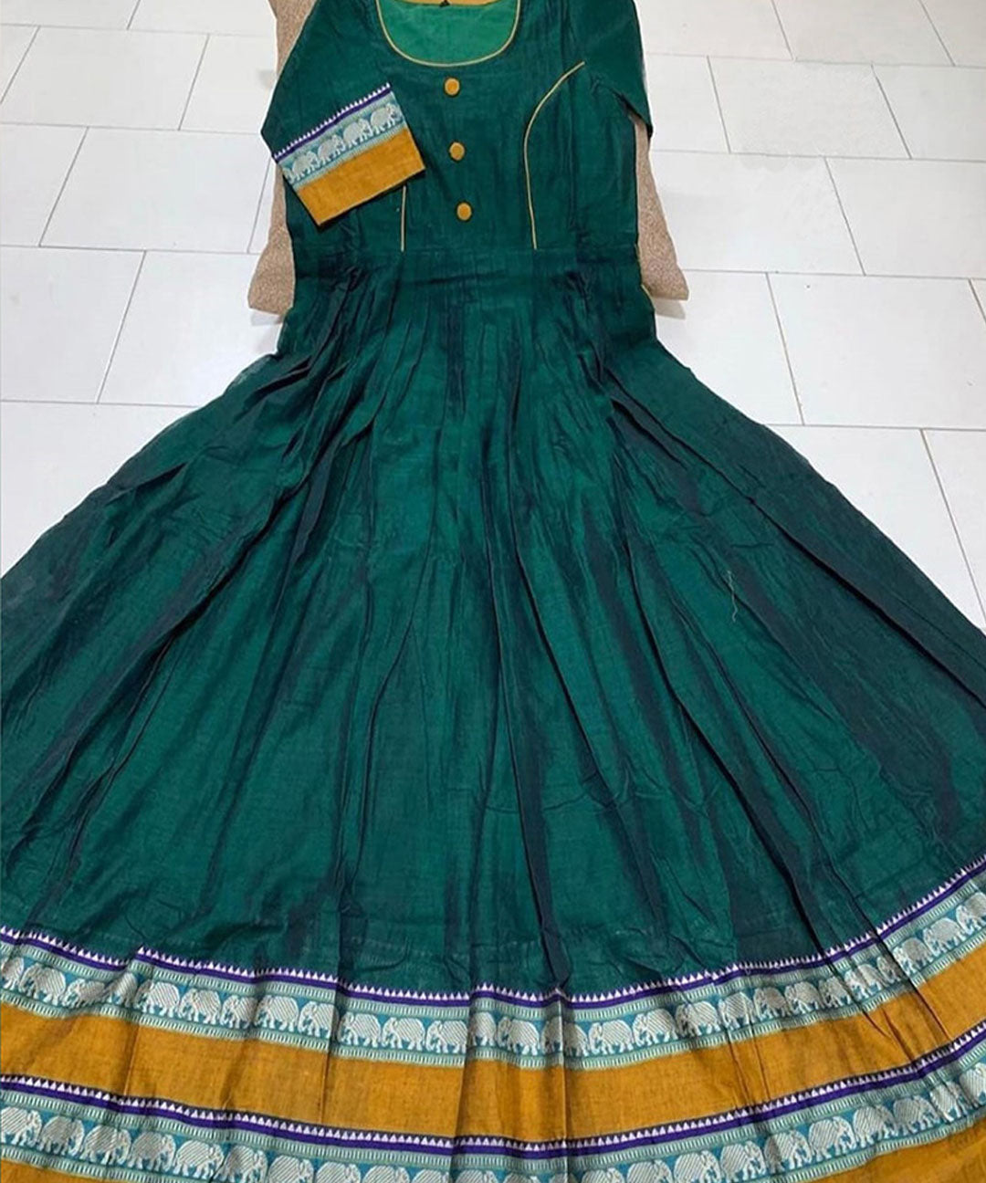 Pleasant dark green colored partywear satin silk gown with trendy print, ideal for stylish and fashionable occasions.