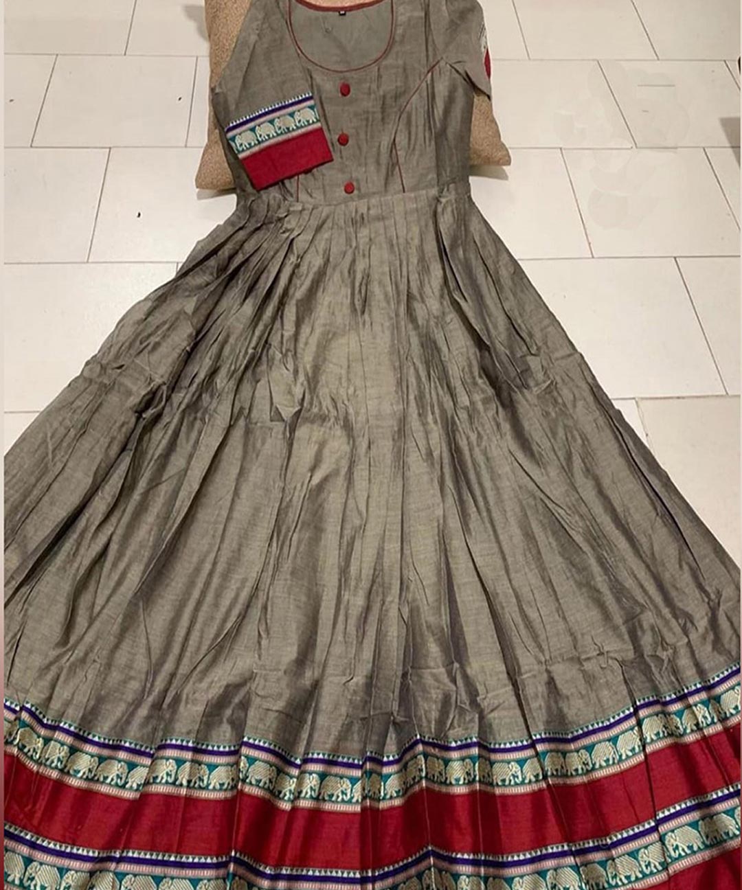 Prominent grey colored partywear satin silk gown with trendy print, ideal for stylish occasions.