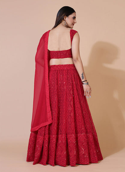Red A-line Lucknowi Chikankari work stitched lehenga choli, ideal for traditional and festive celebrations with intricate embroidery.
