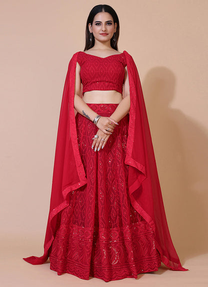Red A-line Lucknowi Chikankari work stitched lehenga choli, ideal for traditional and festive celebrations with intricate embroidery.