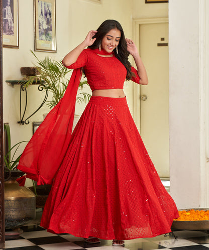 Red A-line lehenga choli with Lucknowi Chikankari work, showcasing intricate embroidery and an elegant design
