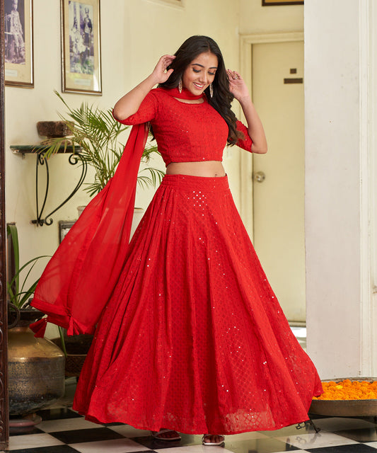 Red A-line lehenga choli with Lucknowi Chikankari work, showcasing intricate embroidery and an elegant design