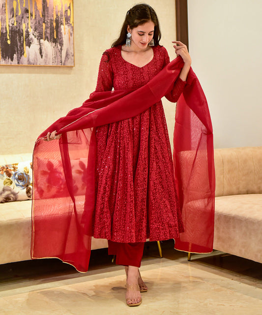 A red georgette Anarkali suit featuring intricate Lucknowi embroidery.