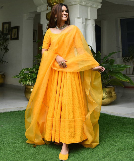 Yellow Designer Anarkali Gown in Cotton adorned with Lucknowi Chikankari Embroidery, showcasing intricate craftsmanship and elegance.